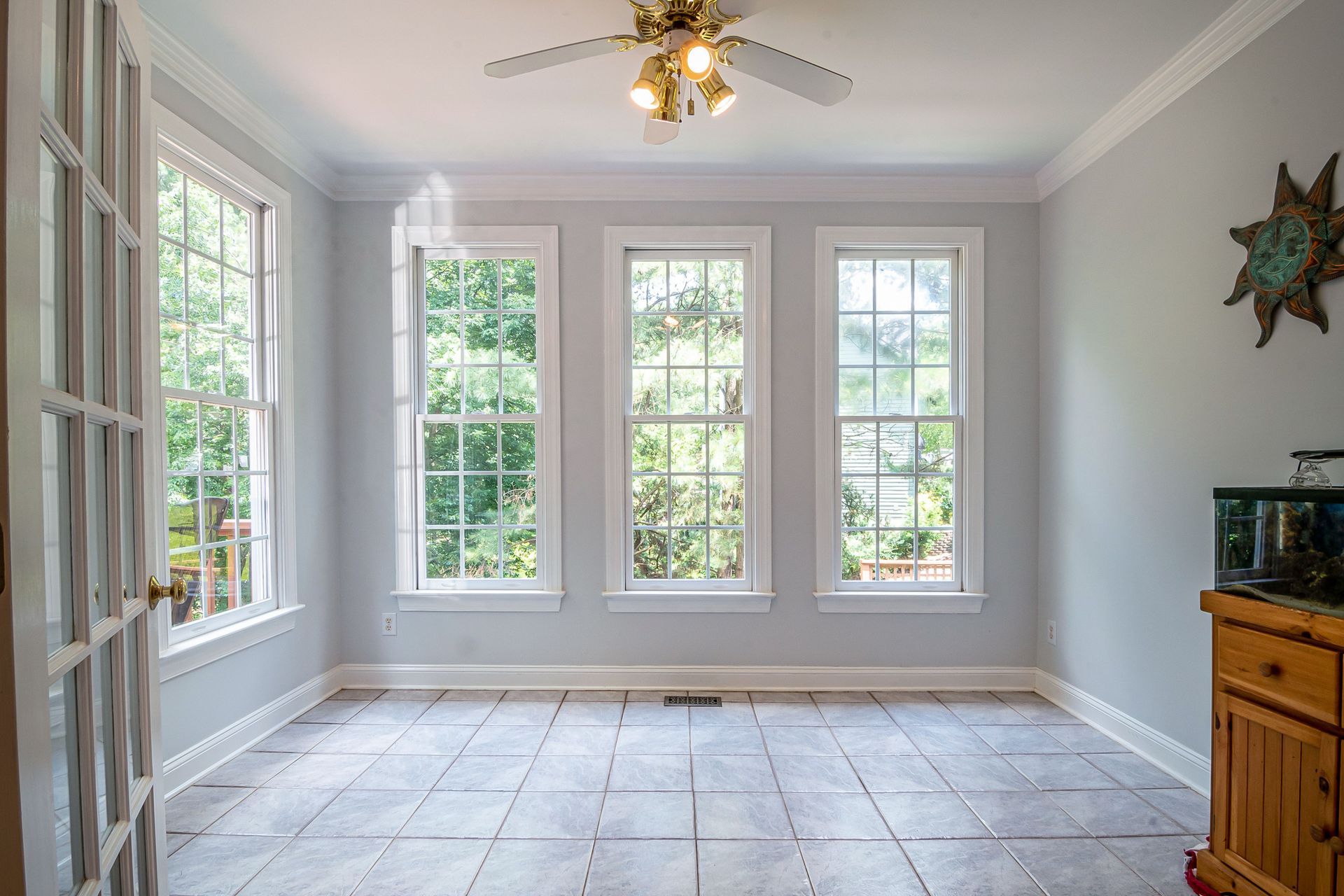 Spacious and bright interior room with large glass windows and tiled floor, perfect for home design inspiration.